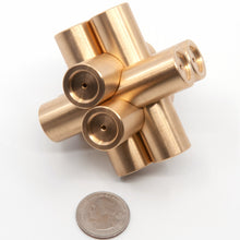 Load image into Gallery viewer, Picture of Brass Monkey Four at a jaunty angle. US quarter in the foreground. Each cylinder is 70mm longs,  with three pairs of mutual perpendicular cylinders interlocking.