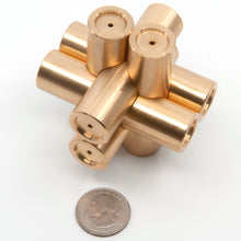 Load image into Gallery viewer, Brass Monkey Four stood upright on two cylindrical pieces. US quarter in foreground shows illustrates scale (70mmx70mmx70mm).