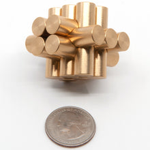 Load image into Gallery viewer, Pygmy puzzle next to a US quarter for size. Or it could be Marmoset. Both puzzles have very different assemblies but identical appearances.