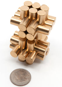 A pair of stacked miniature monkey metal mind bending puzzles with a US quarter for size comparison.