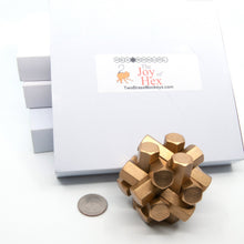 Load image into Gallery viewer, One hex metal burr puzzle, one US quarter and four boxes.