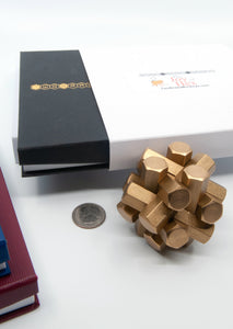 Assembled Bish Bash Bosch puzzle next to a US quarter for size.