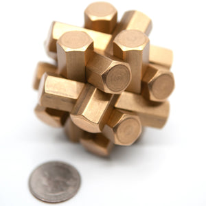 Hex puzzle with a blurred US quarter in front. The Two Brass Monkey's photographer assures us this is artistic.