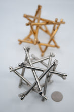 Load image into Gallery viewer, Two assembled Nova Plexus Puzzles. Limited Stainless Steel version in foreground brass copy n background.