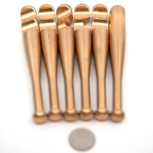 Load image into Gallery viewer, Six brass bat piecces of the heavy hitter puzzle laid out in a row. They have the same notches as Brass Monkey one, but need a whole lot more dexterity to assemble.