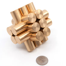 Load image into Gallery viewer, Assembled Kong puzzle at a quirky angle next to a US quarter to give a sense of scale.