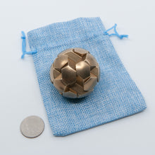 Load image into Gallery viewer, A nice shiny gobstopper resting on a blue ball bag.
