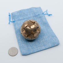 Load image into Gallery viewer, A nice shiny gobstopper resting on a blue ball bag.