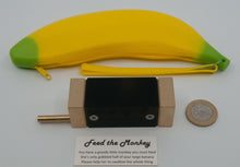 Load image into Gallery viewer, Feed the Monkey Puzzle together with package. We decided to have fun with this one, and use the inspired choice of a rubber banana, for some somewhat unusual packaging.