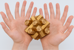 AI Generated copy of the puzzle shown cupped in a pair of hands each with six fingers and two thumbs.