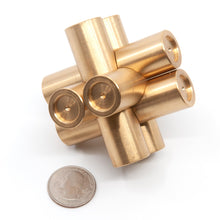 Load image into Gallery viewer, Brass Monkey One tilted at a jaunty angle. A US quarter in the foreground illustrates the size of this solid brass puzzle.
