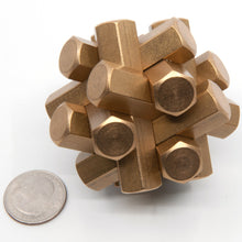 Load image into Gallery viewer, Assembled Joy of Hex puzzle next to a quarter for size. All three puzzles look identical when assembled but have very different assemblies.
