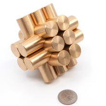 Load image into Gallery viewer, Assembled Kong puzzle at a quirky angle next to a US quarter to give a sense of scale.
