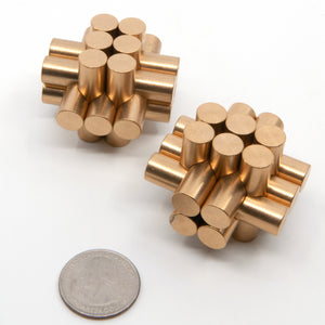 Pygmy and Marmoset miniature thirteen piece brass burr puzzles next to a US quarter to illustrate size